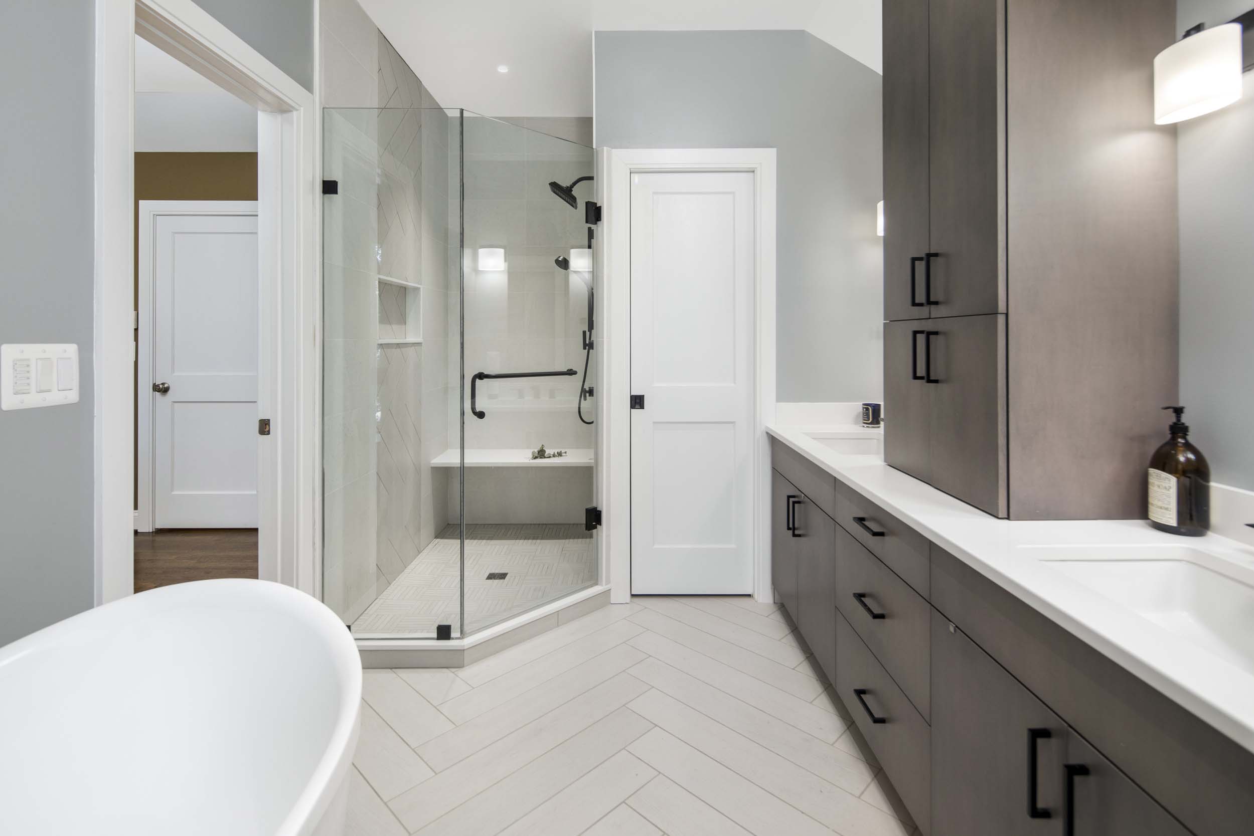Modern bathroom vanity with double sinks, custom cabinetry, and designer lighting fixtures