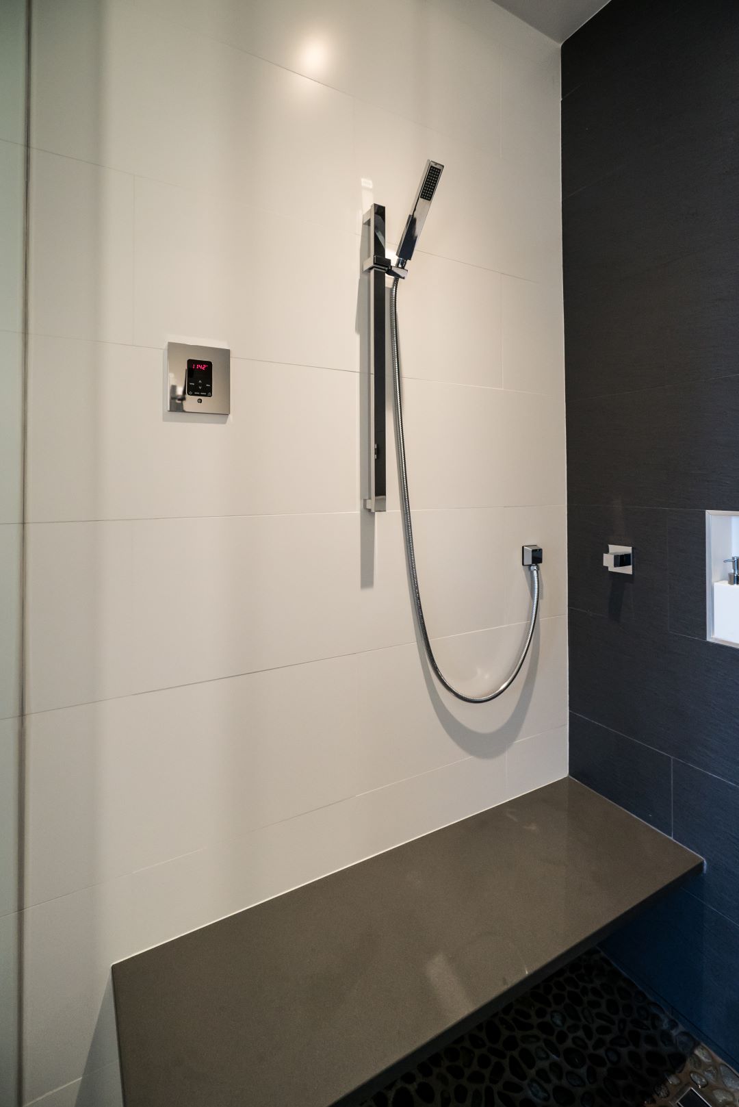 Wall-mounted toilet and floating vanity creating clean, uncluttered lines in urban bathroom renovation