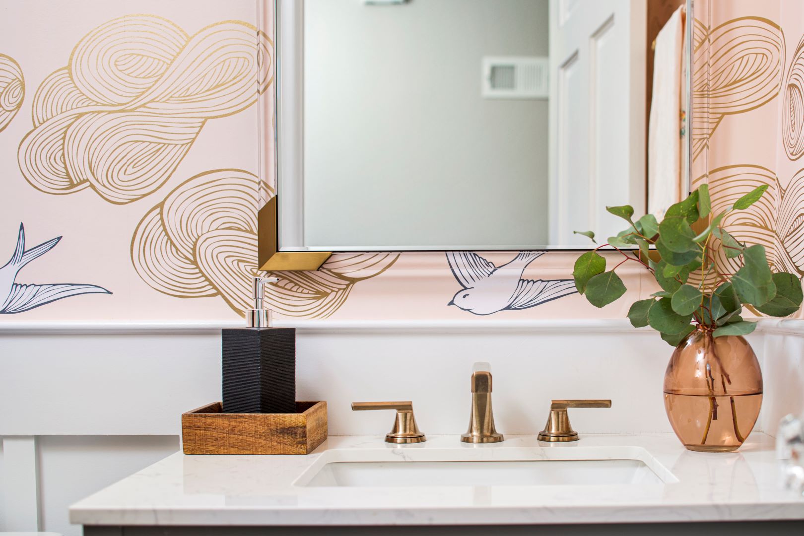 Elegant powder room featuring vibrant patterned wallpaper, contemporary fixtures, and thoughtful design details for entertaining