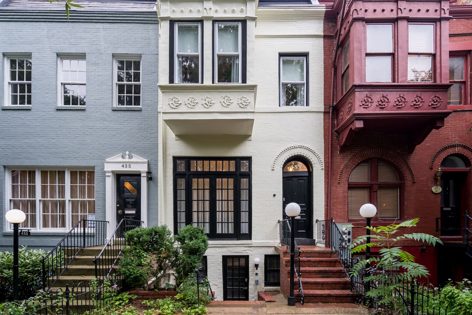 Side angle of Capitol Hill rowhouse showcasing renovated exterior with attention to historical accuracy and period details