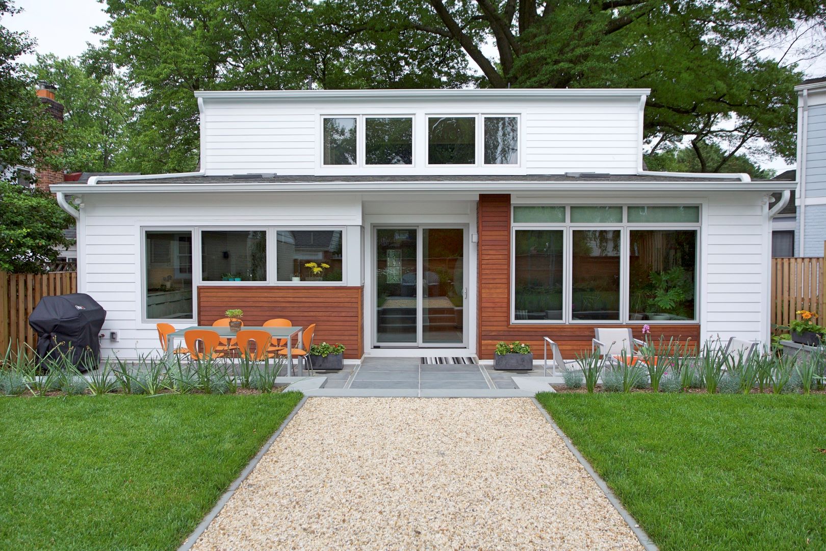Transformed Cape Cod home in Silver Spring featuring modern rear addition with mid-century architectural elements and expanded outdoor living space