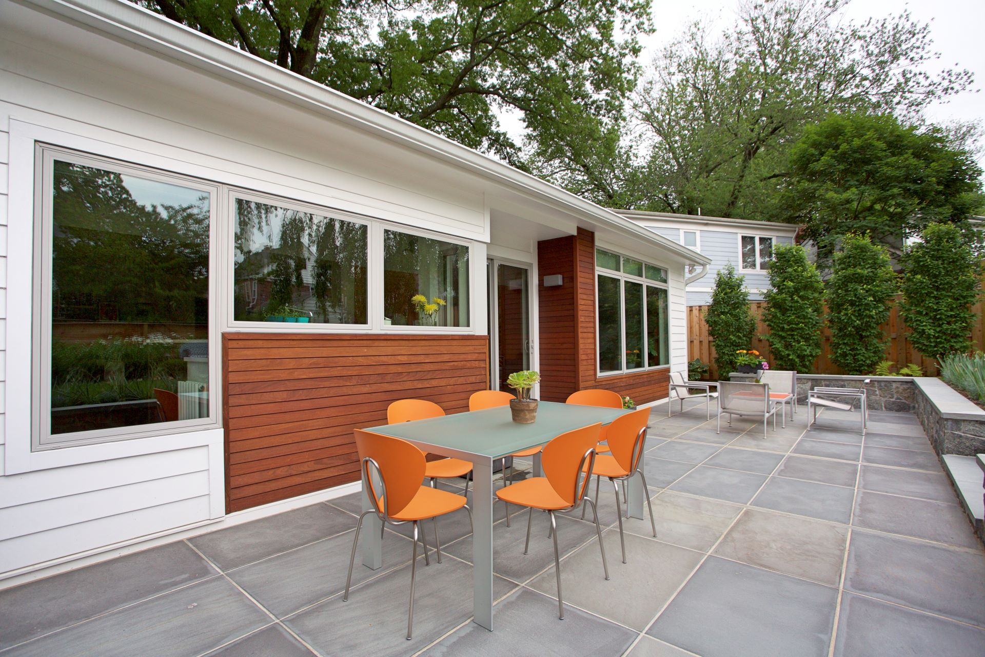 Side perspective of renovated Silver Spring home showcasing seamless integration of addition with original Cape Cod structure