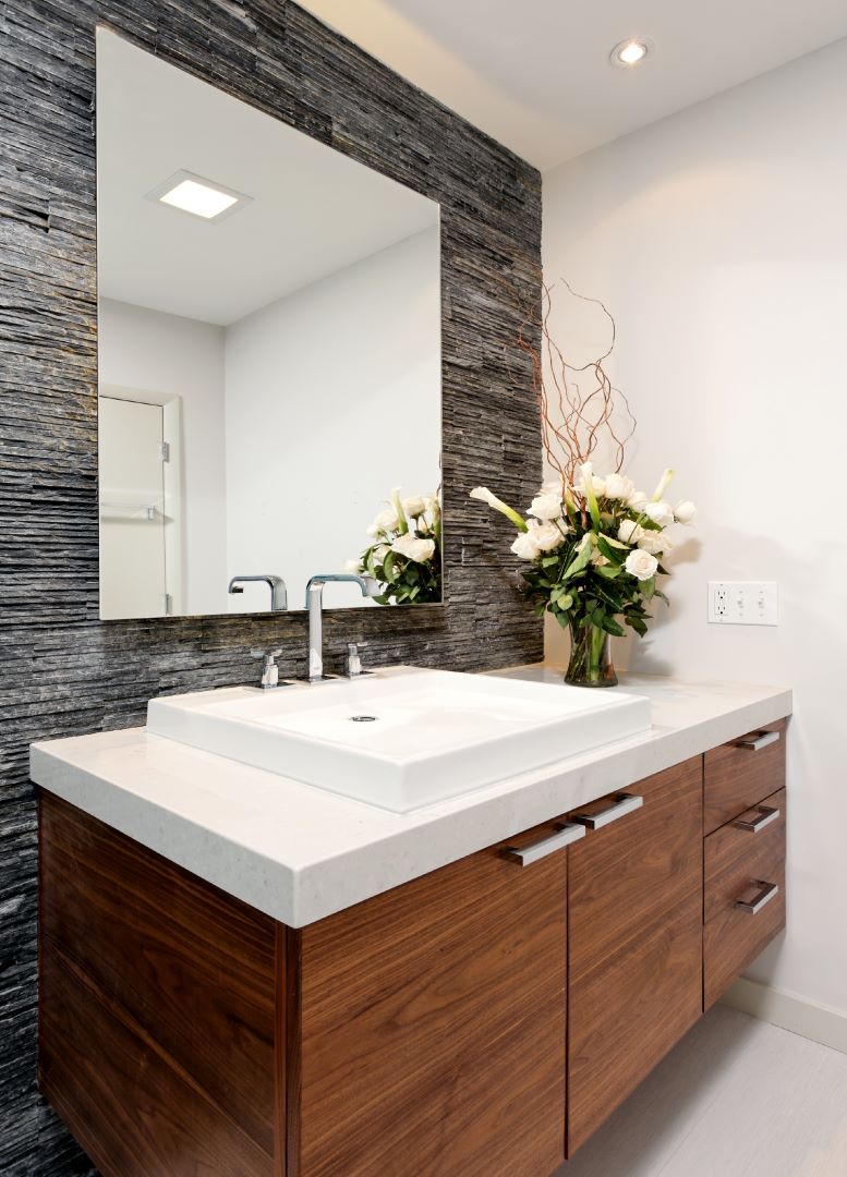 Close-up of custom walnut vanity with integrated sink and carefully selected fixtures in Arlington bathroom