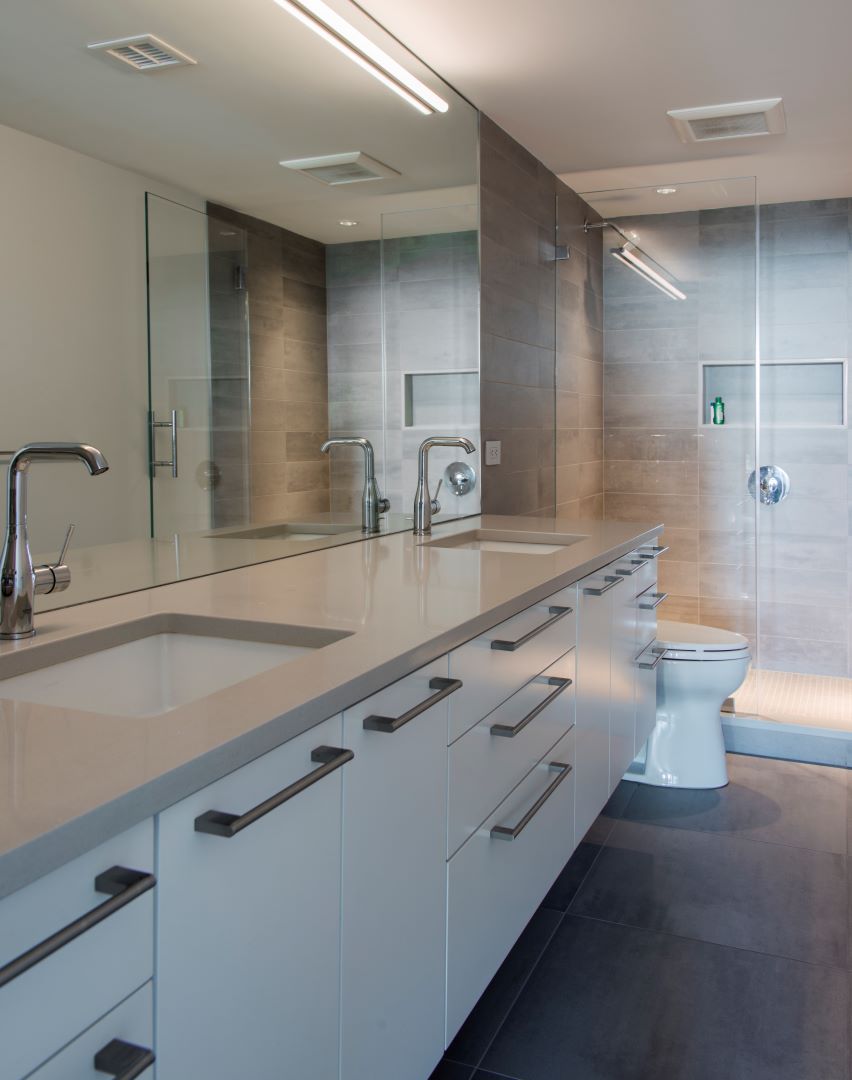 Modern urban bathroom with clean lines, contemporary fixtures, and elegant finishes in renovated downtown DC executive condo