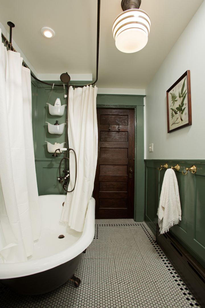 Beautifully preserved clawfoot tub in historic Takoma Park bathroom renovation featuring period details and careful restoration