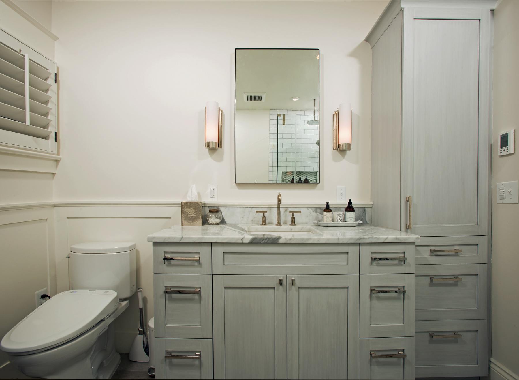 Historic woodwork details preserved and highlighted in bathroom renovation to maintain home's character