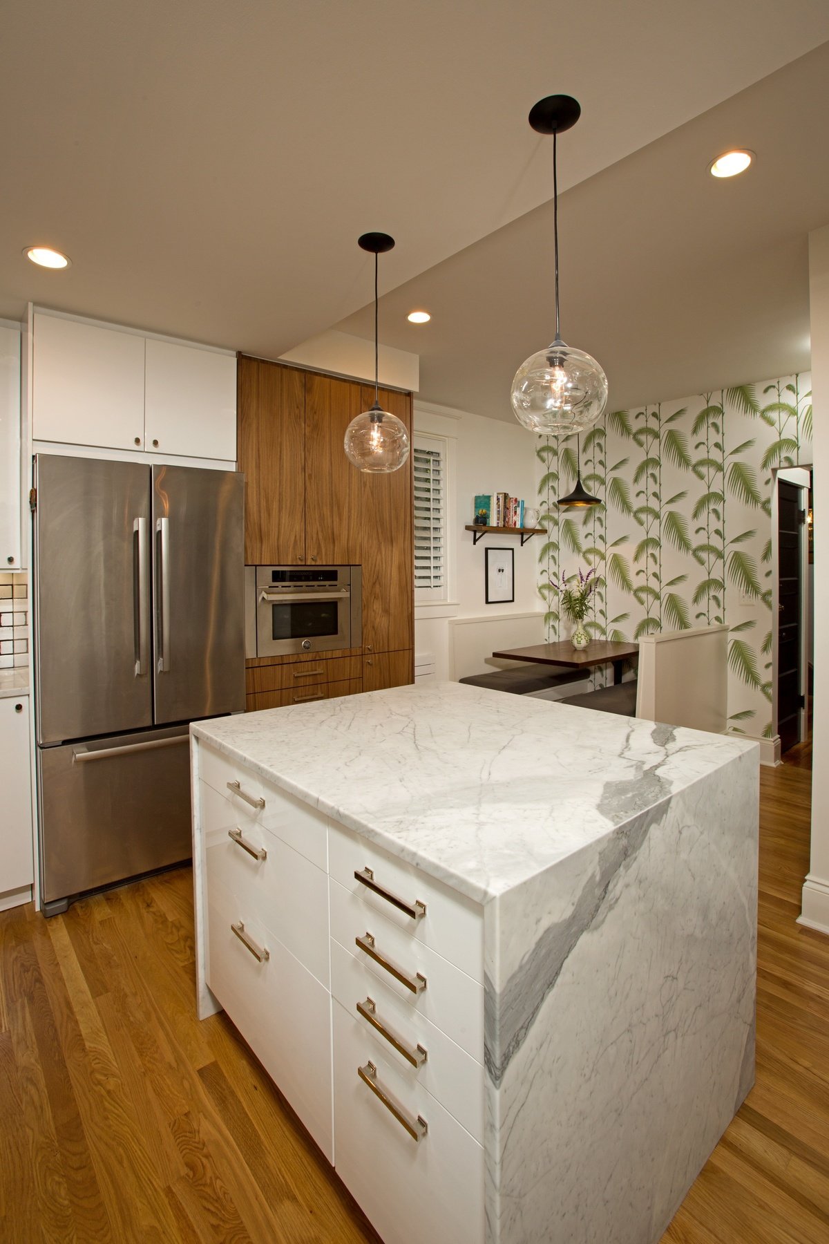 Kitchen view showing open concept design created through modest addition while preserving historic character