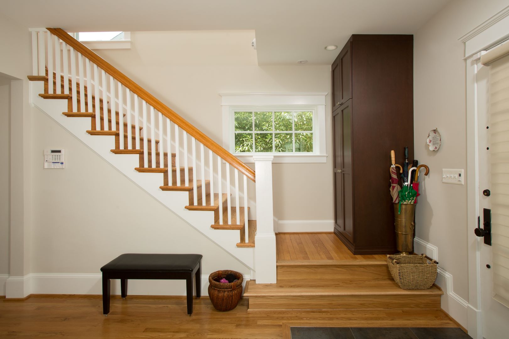 Modern staircase featuring sleek lines, artistic design elements, and colorful accents reflecting homeowner's graphic artist style