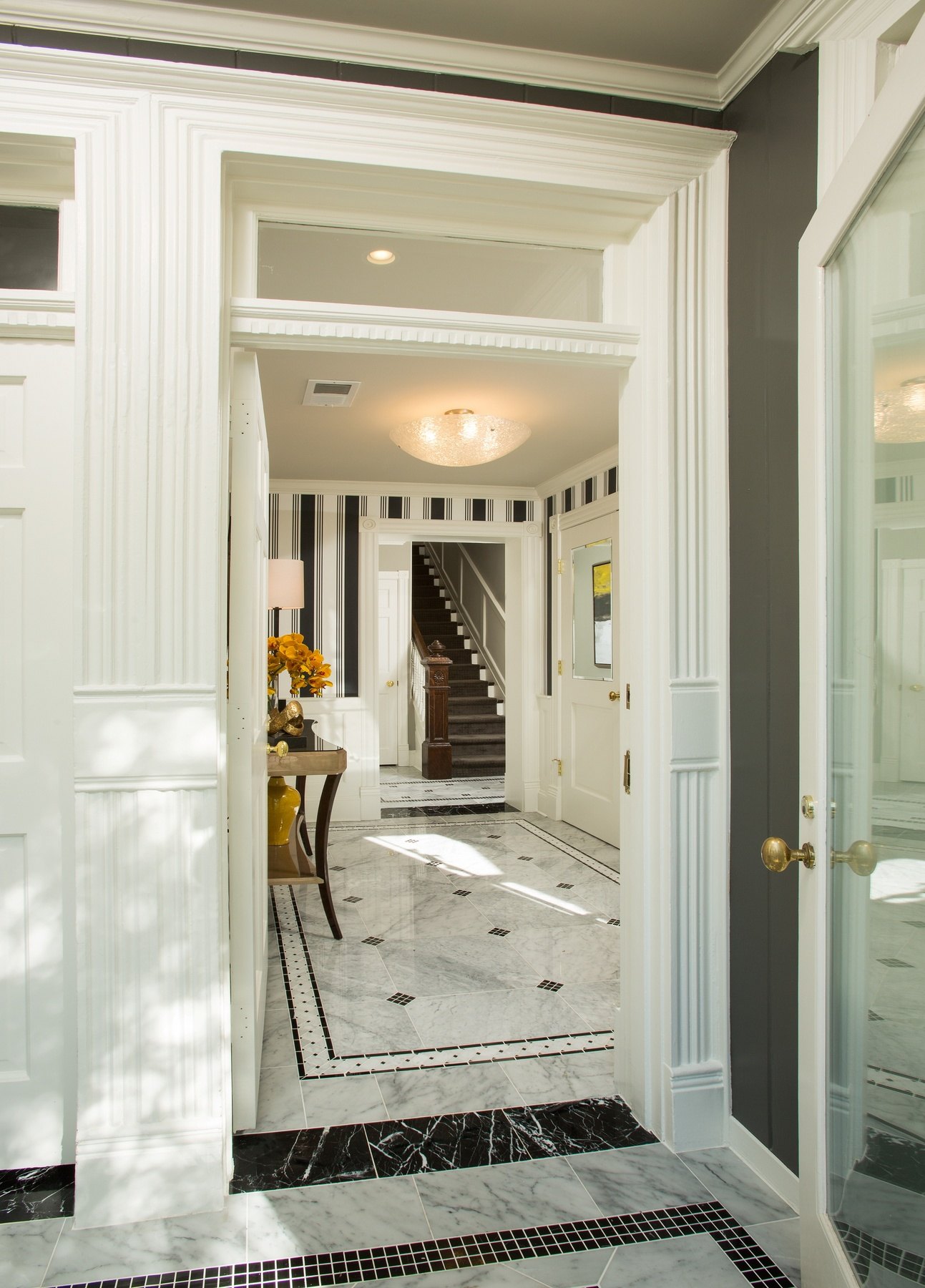 Elegant entryway with restored wood flooring, period-appropriate trim, and careful attention to historic Capitol Hill rowhouse details