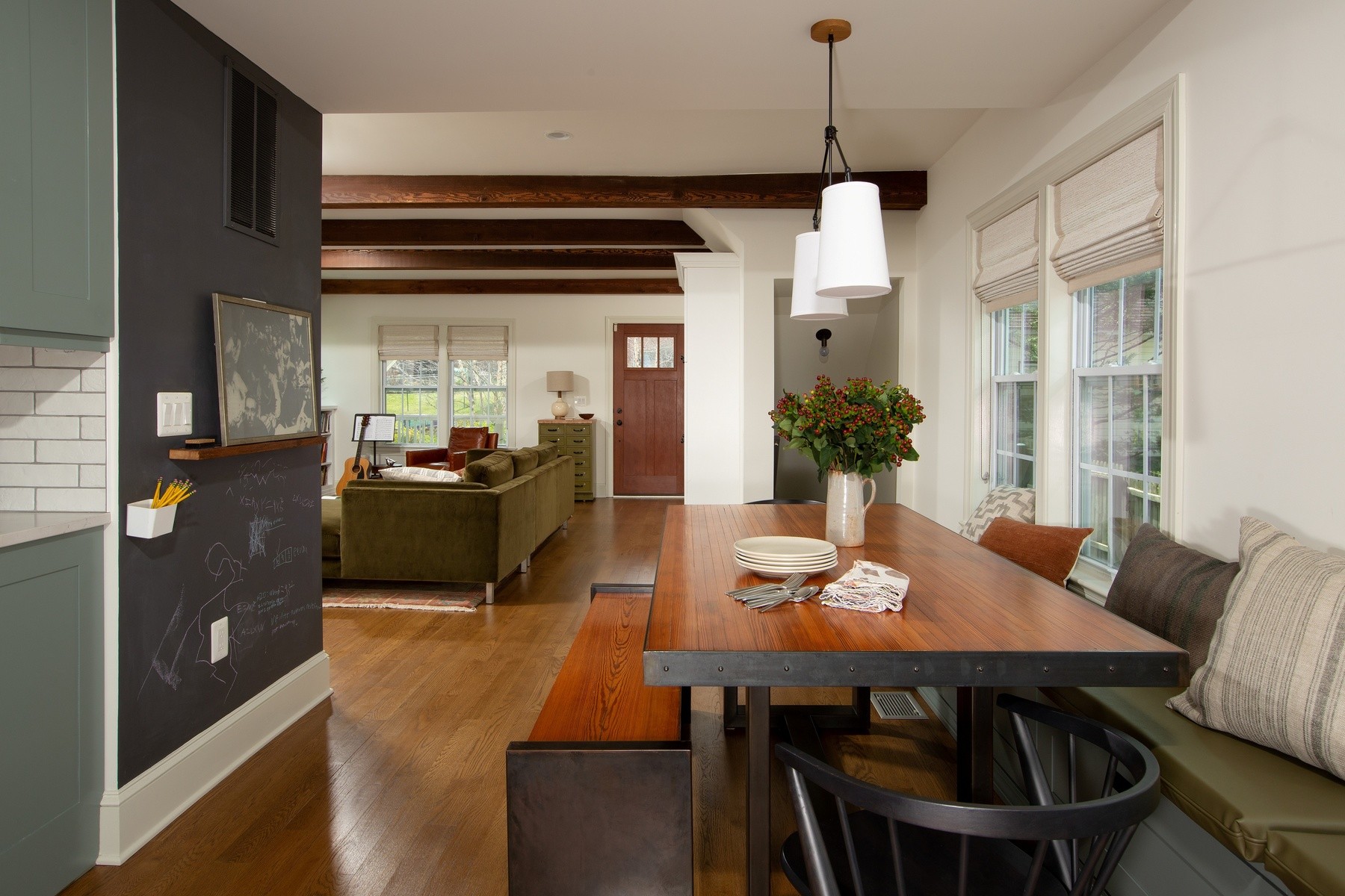 Corner view of relocated kitchen showcasing improved layout, premium appliances, and connection to living spaces