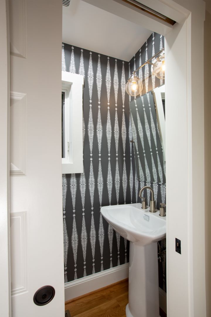 Dedicated powder room with premium fixtures and thoughtful design for office visitors in Crestwood home addition