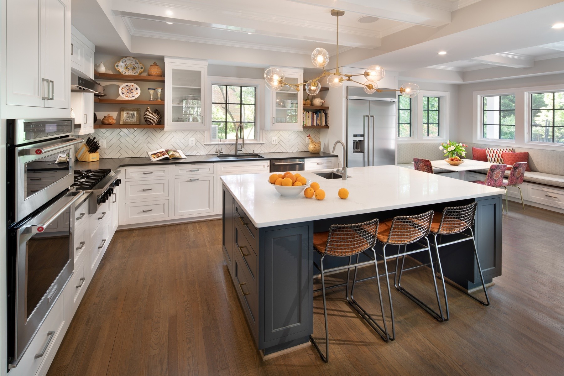 Elegant kitchen in expanded 1937 colonial featuring custom cabinetry, premium countertops, and modern appliances with traditional details