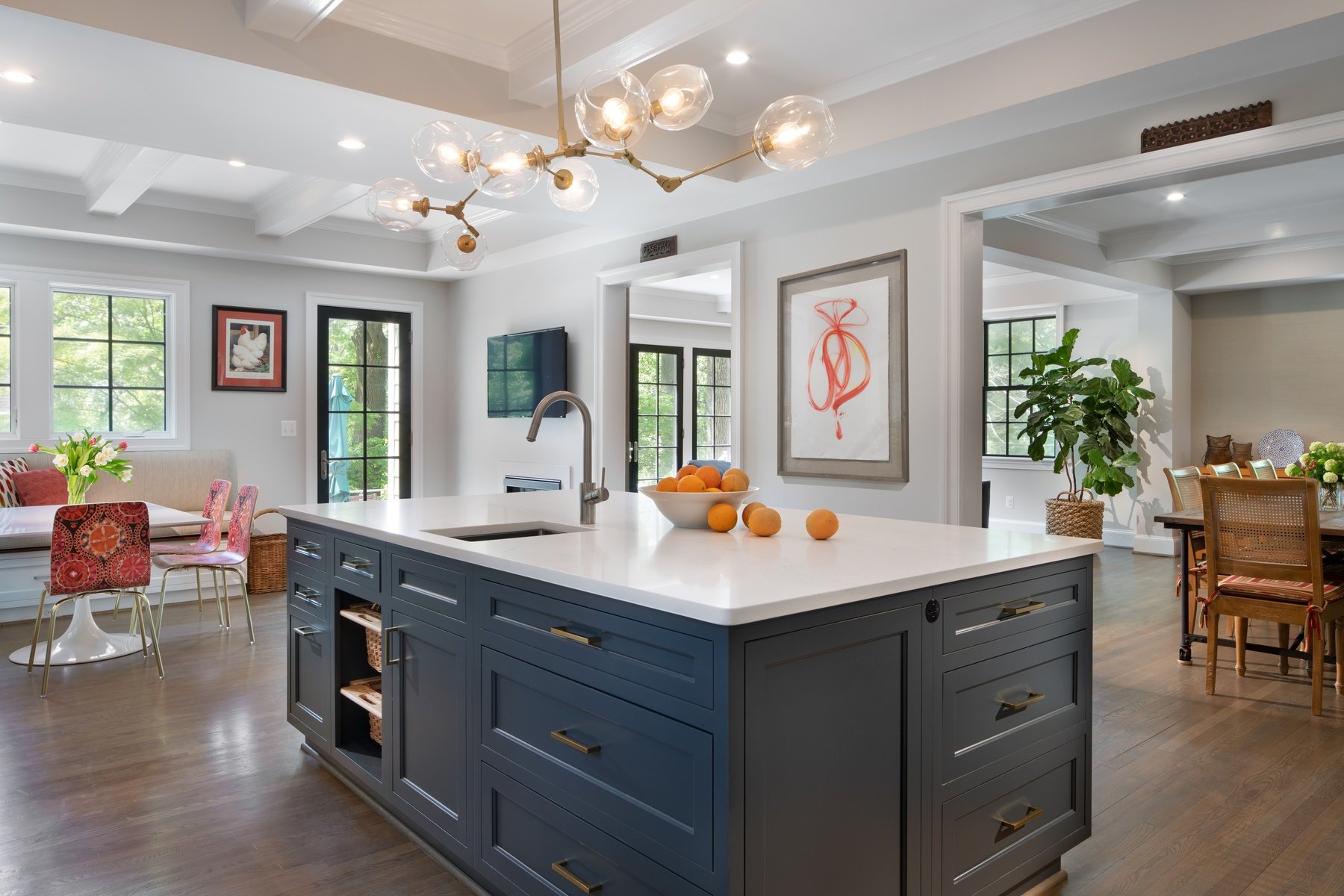 Kitchen island with pendant lighting, quality materials, and open connection to adjacent living spaces in Somerset home