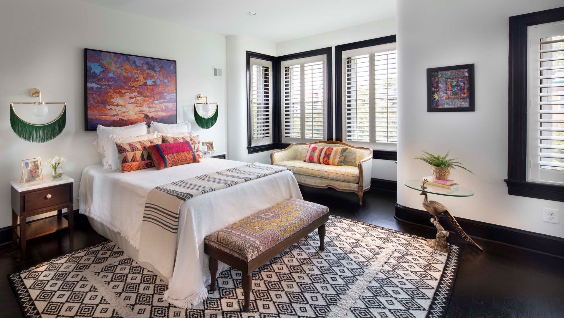 Elegant primary bedroom in Adams Morgan rowhouse featuring ebony wood floors, architectural details, and sophisticated design elements