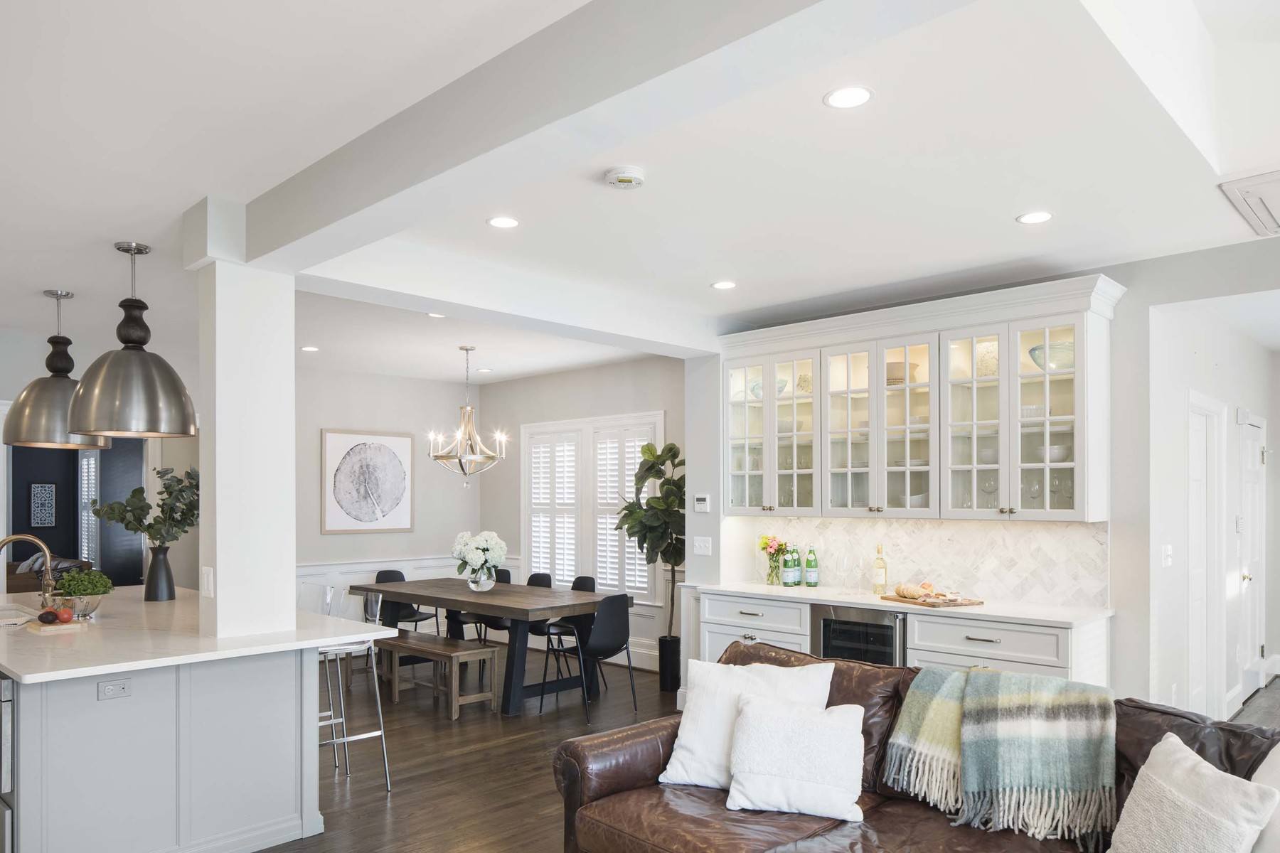 Dining space with custom built-ins, transitional design elements, and chair rail adding refined touches to open layout