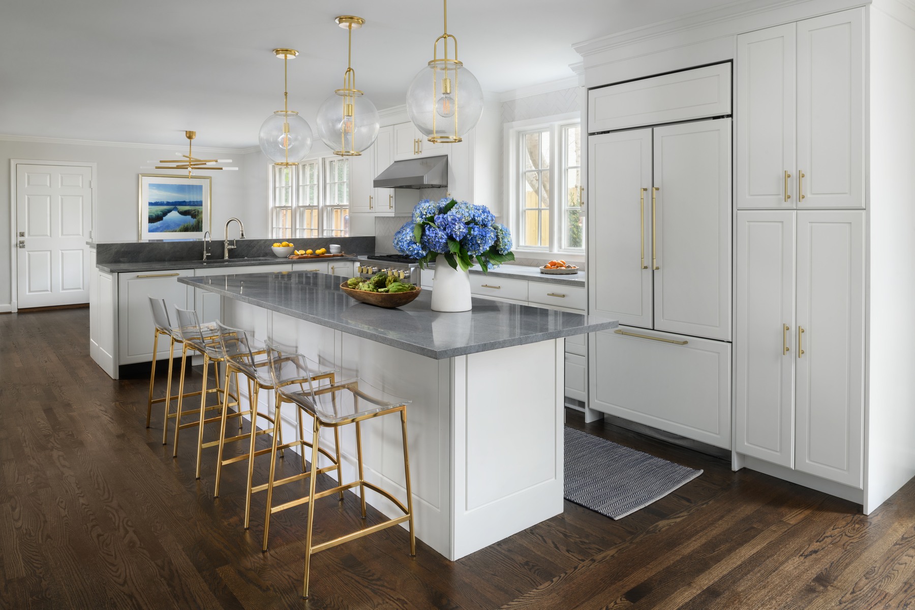 Dining area with custom built-ins, contemporary lighting, and open connection to kitchen in Spring Valley renovation