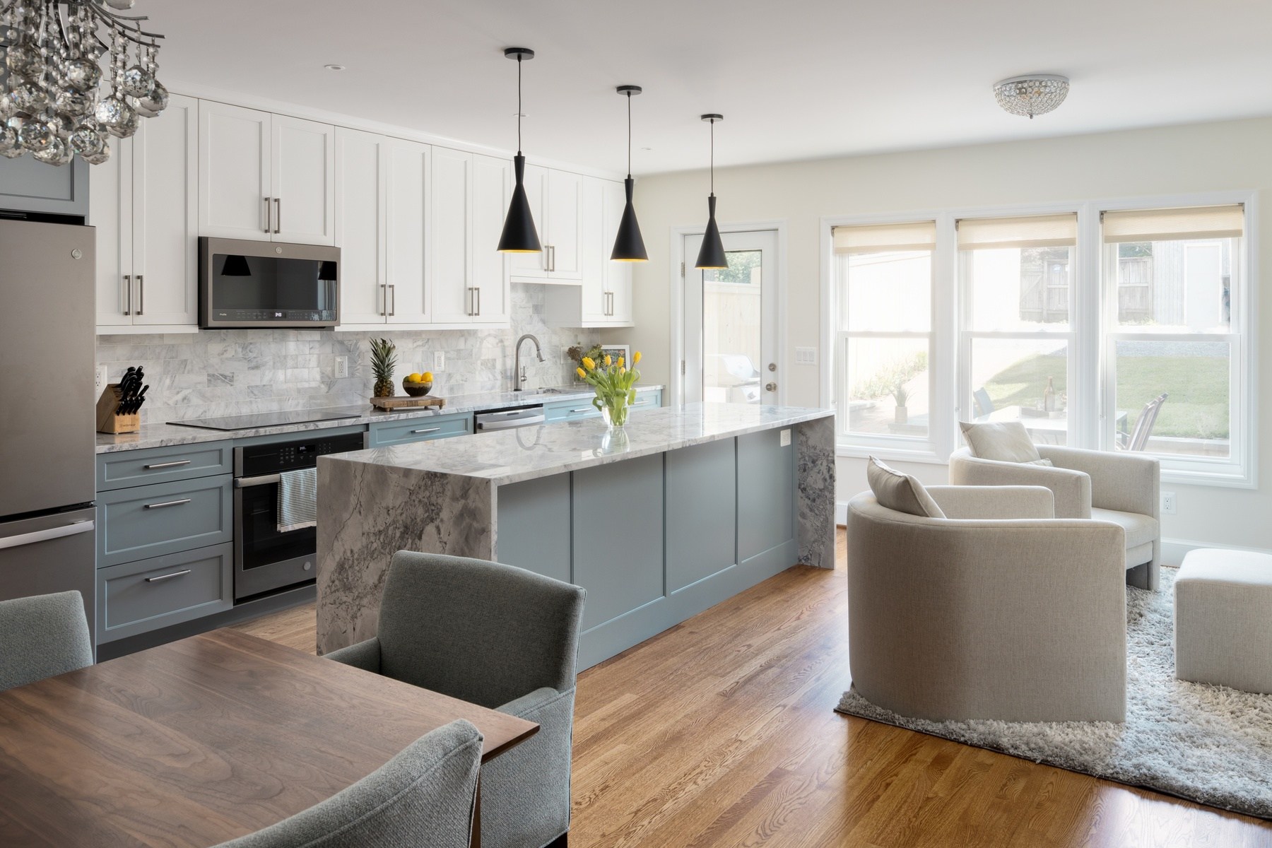 Transformed Burleith rowhouse kitchen featuring three-story rear addition with open concept design, premium finishes, and abundant natural light