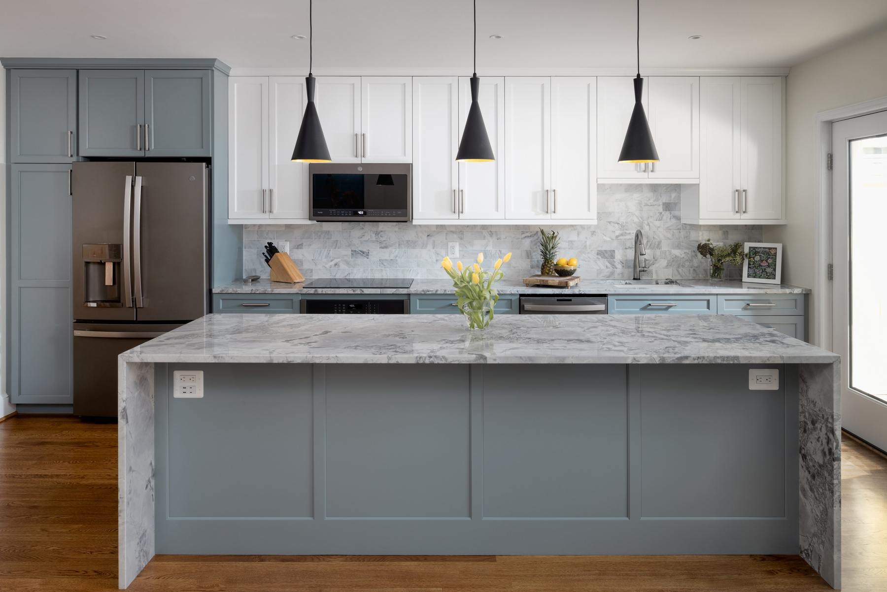 Kitchen view showcasing premium appliances, thoughtful storage solutions, and connection to outdoor patio in DC rowhouse