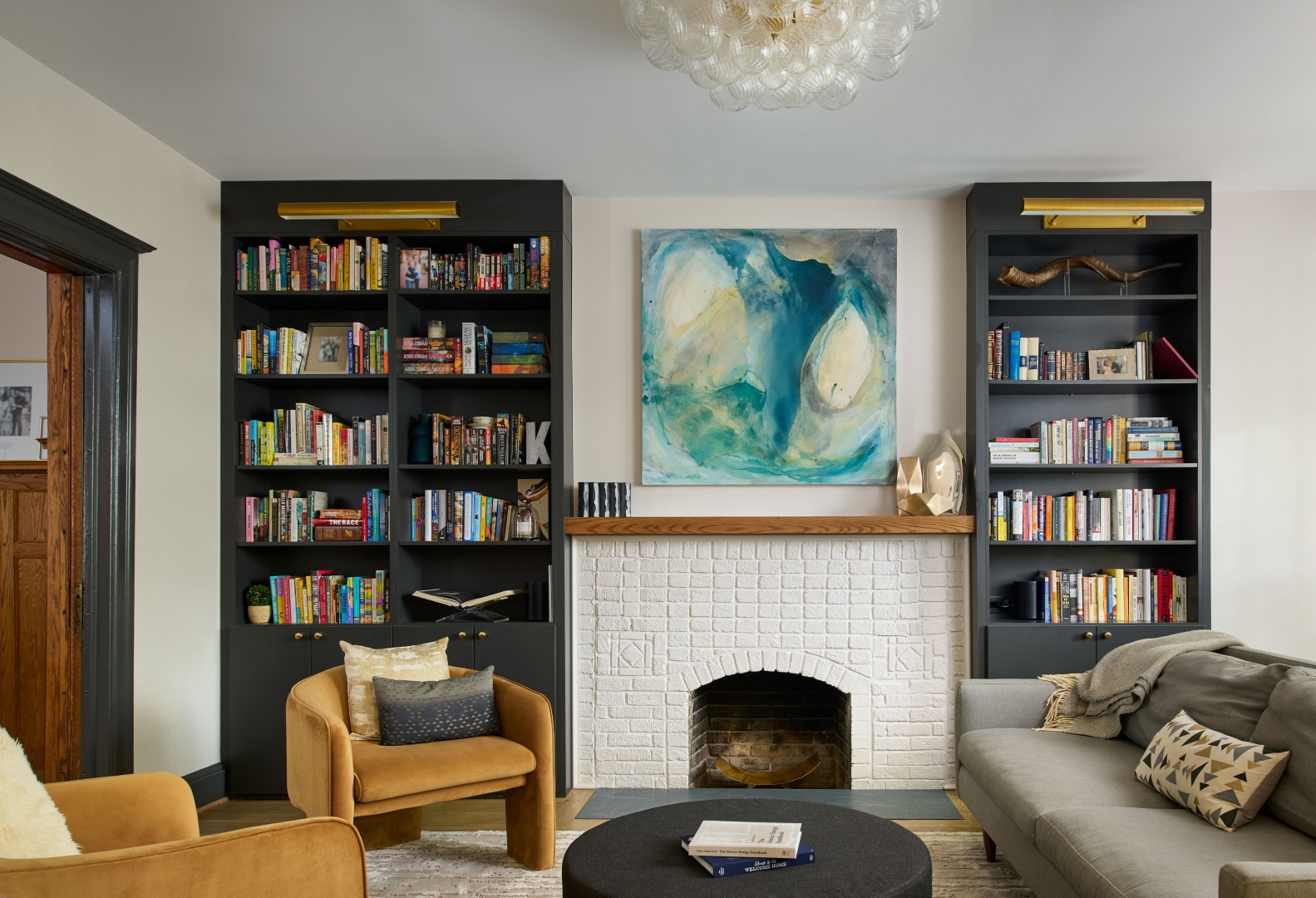 Modern kitchen with white cabinetry, elegant island, and preserved historic elements in revitalized Garfield home