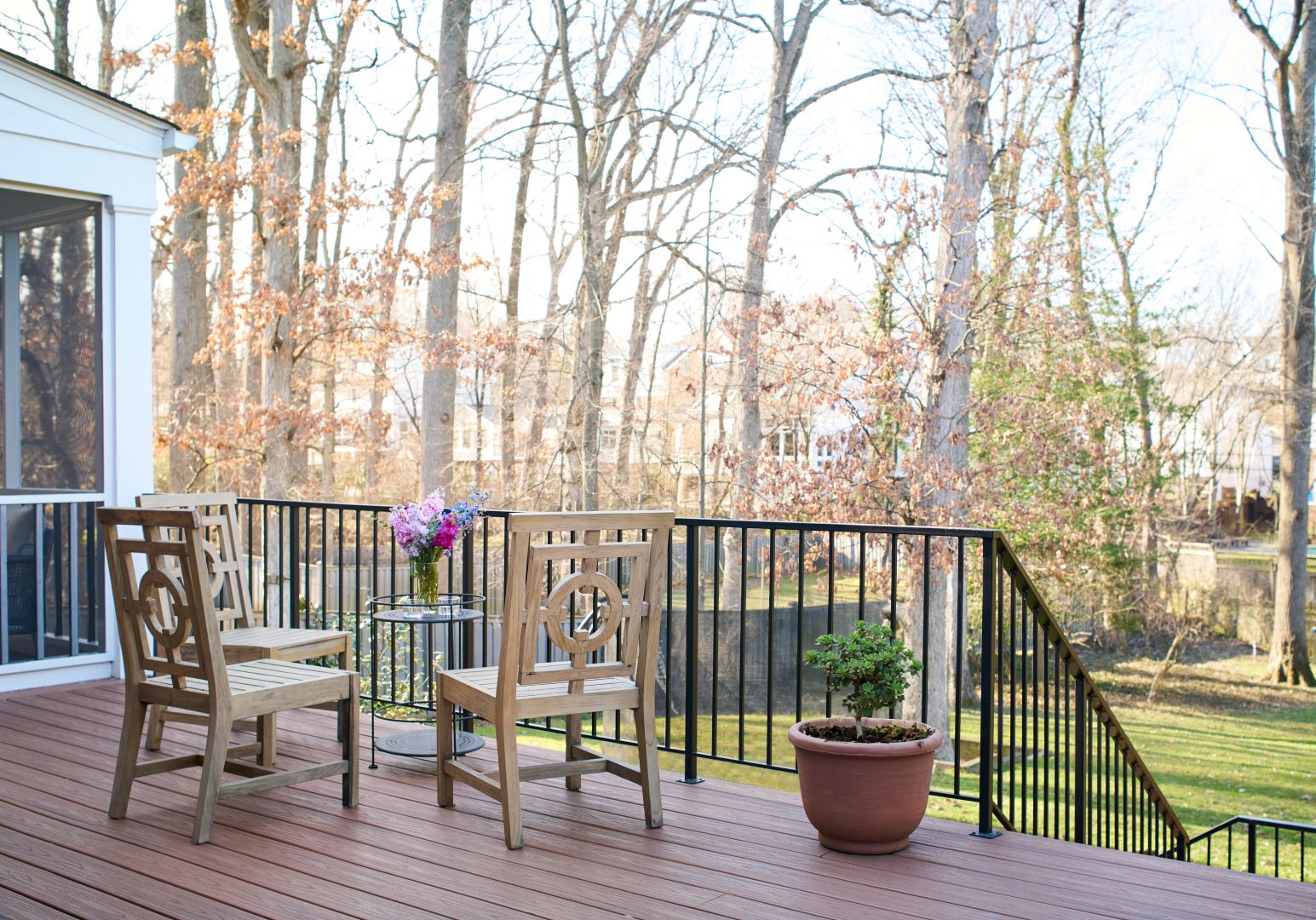 Elevated Trex deck with white railings and colonial styling providing expanded outdoor living space for Chevy Chase home
