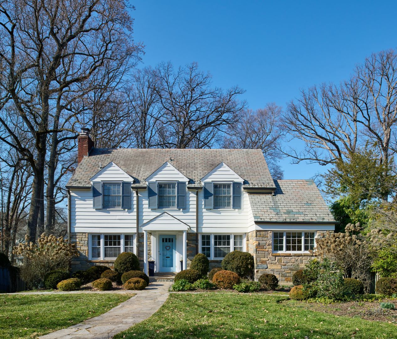Garden view of Chevy Chase home showing relationship between deck, landscaping, and classic colonial revival architecture
