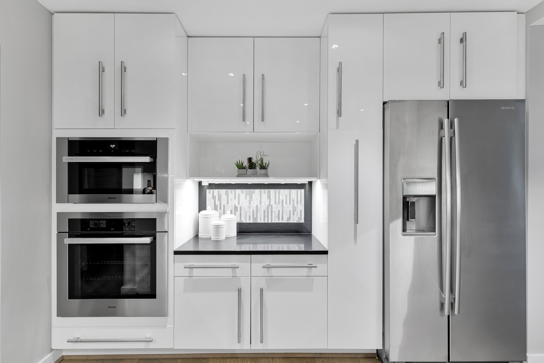 Dining area adjacent to renovated kitchen featuring contemporary furnishings and connection to living space