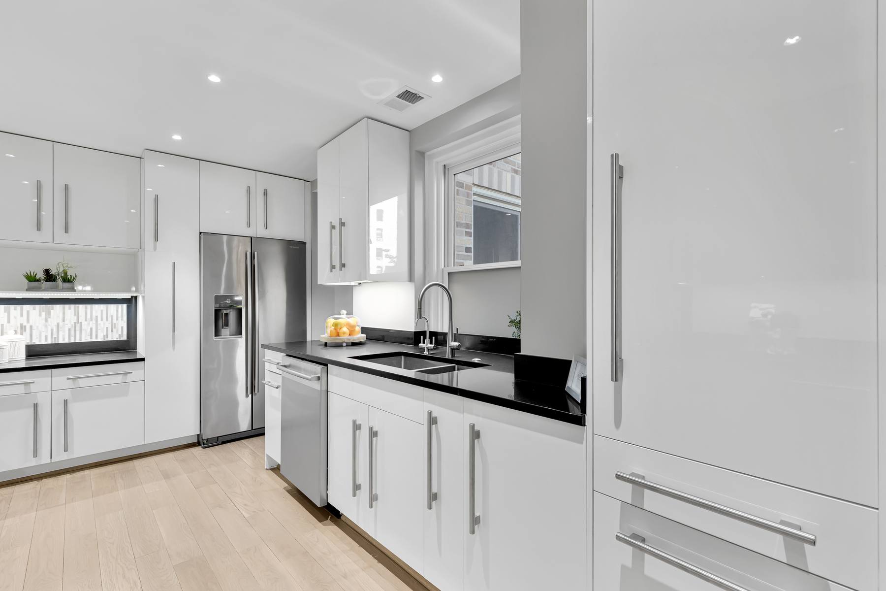 Detail of kitchen featuring premium materials, integrated appliances, and sophisticated design in Kalorama apartment