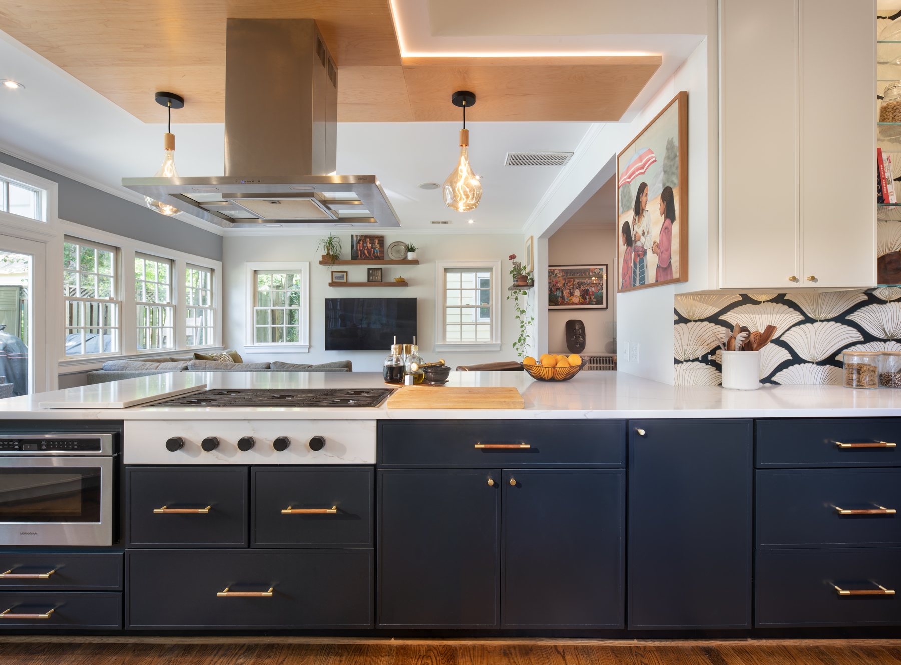 Contemporary kitchen with sleek flat-panel cabinetry, bold wallpaper, and warm wood ceiling details in Chevy Chase home
