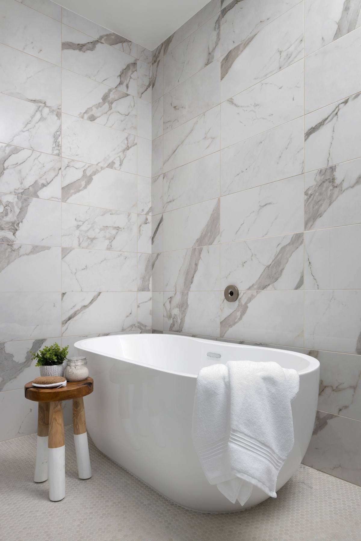 Luxurious primary bathroom featuring elegant freestanding tub, custom vanity, and refined details in Dupont Circle rowhouse