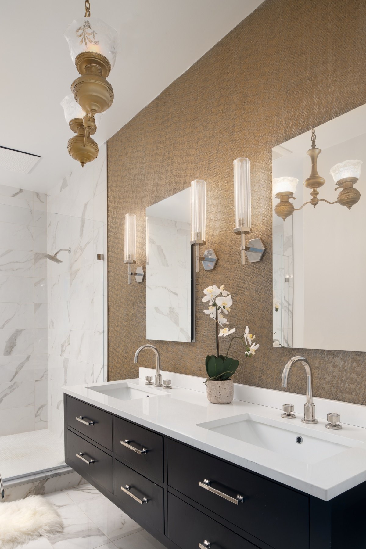Spa-like shower enclosure with premium fixtures, designer tile, and thoughtful lighting in renovated DC bathroom