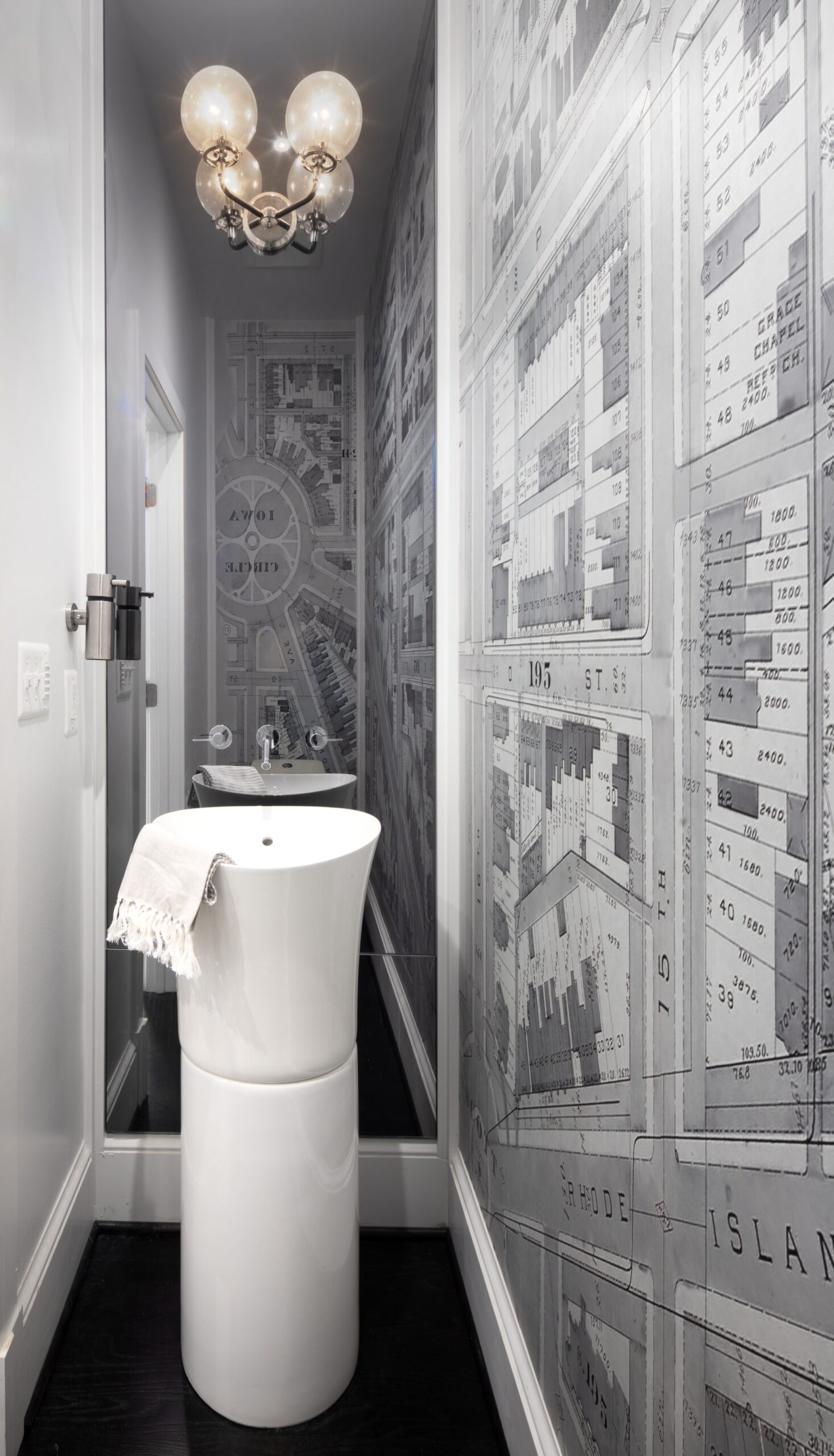Powder room featuring elegant sink, refined lighting, and sophisticated finishes in modernized DC rowhouse