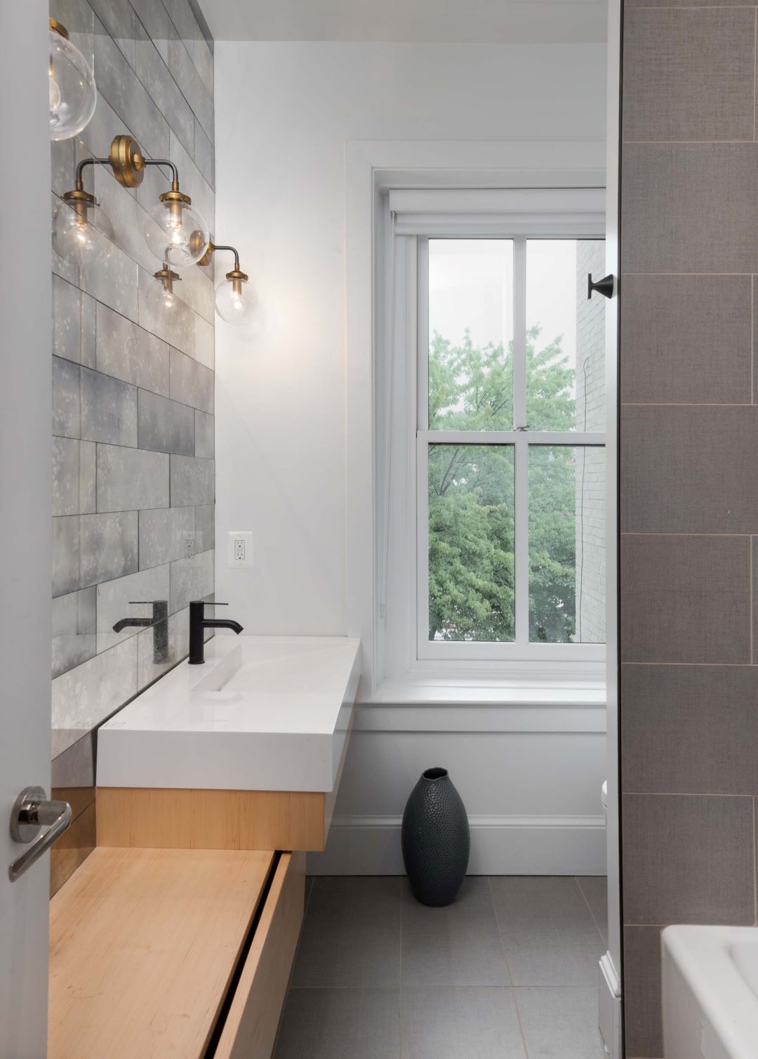 Secondary bathroom with contemporary fixtures, stylish tilework, and functional layout in Dupont renovation