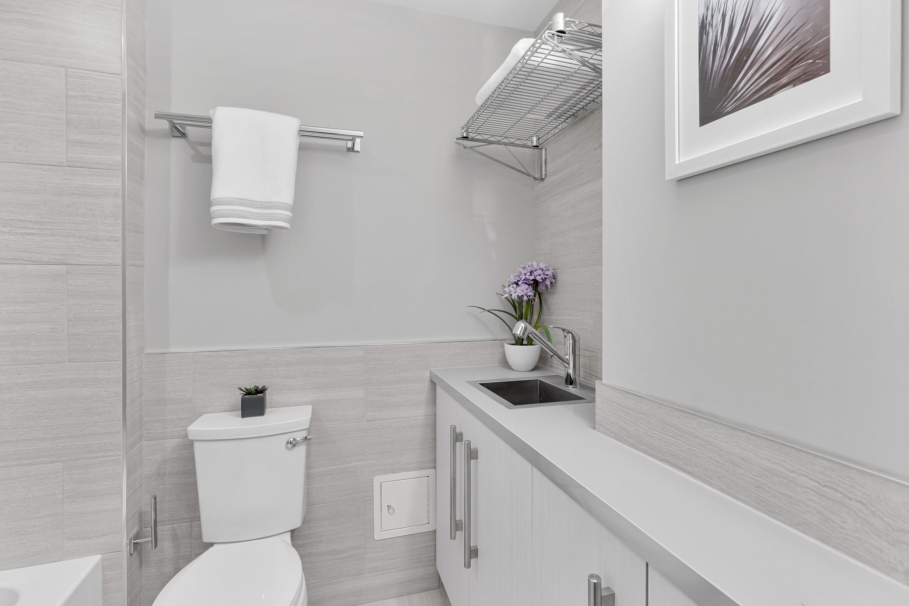 Shower enclosure with premium tile, glass door, and luxurious fixtures in transformed Kalorama bathroom