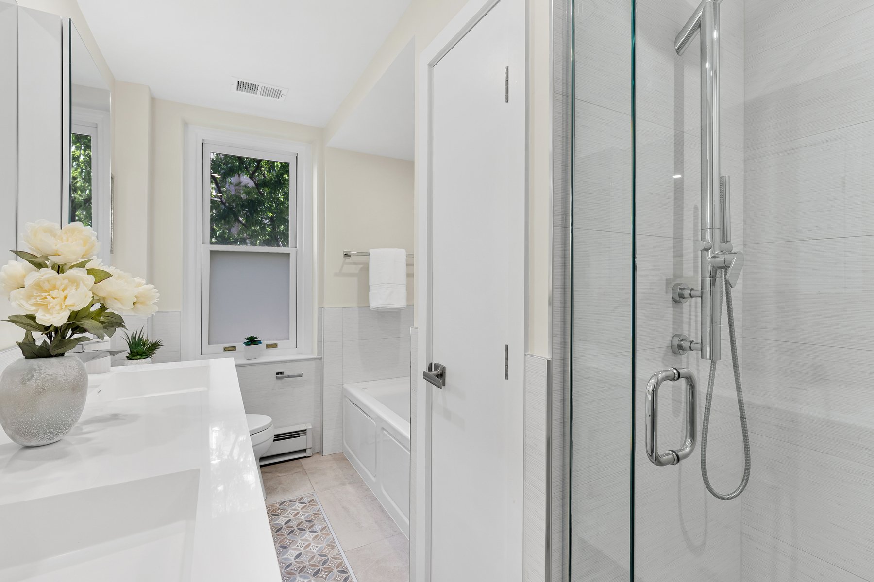 Hall bathroom with contemporary design, quality finishes, and thoughtful layout in modernized apartment