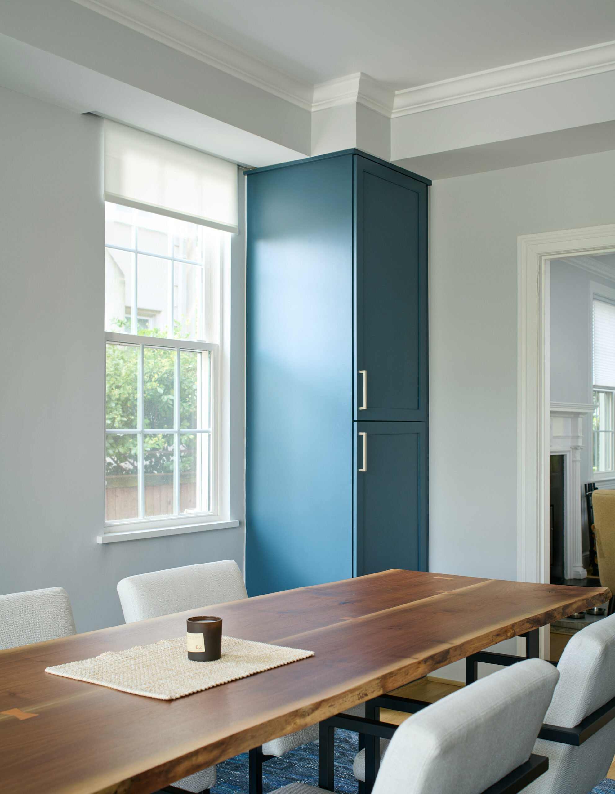 Kitchen island with seating, functional workspace, and modern pendant lighting in transformed Woodley Park interior