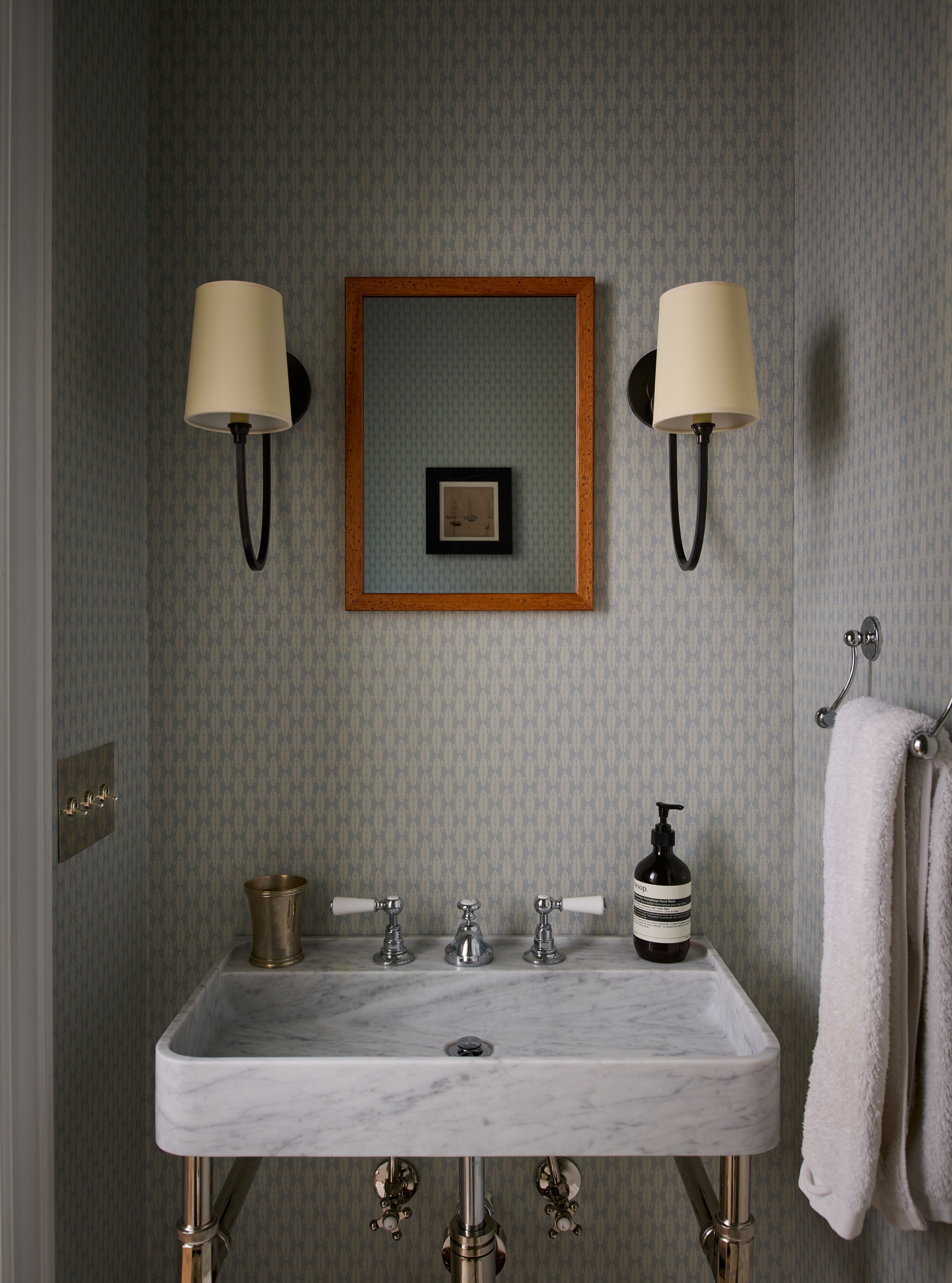 Renovated powder room featuring elegant fixtures, refined finishes, and optimized layout in first-floor update