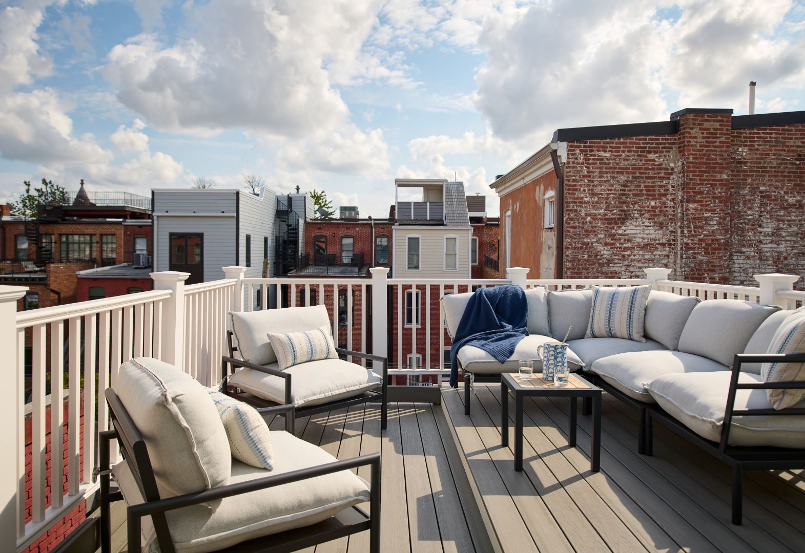 Third floor rear deck providing additional outdoor space with comfortable seating and private urban oasis