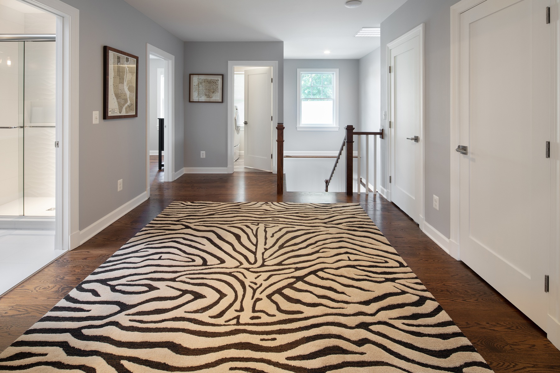 Primary suite walk-in closet with custom storage solutions and efficient organization in expanded home