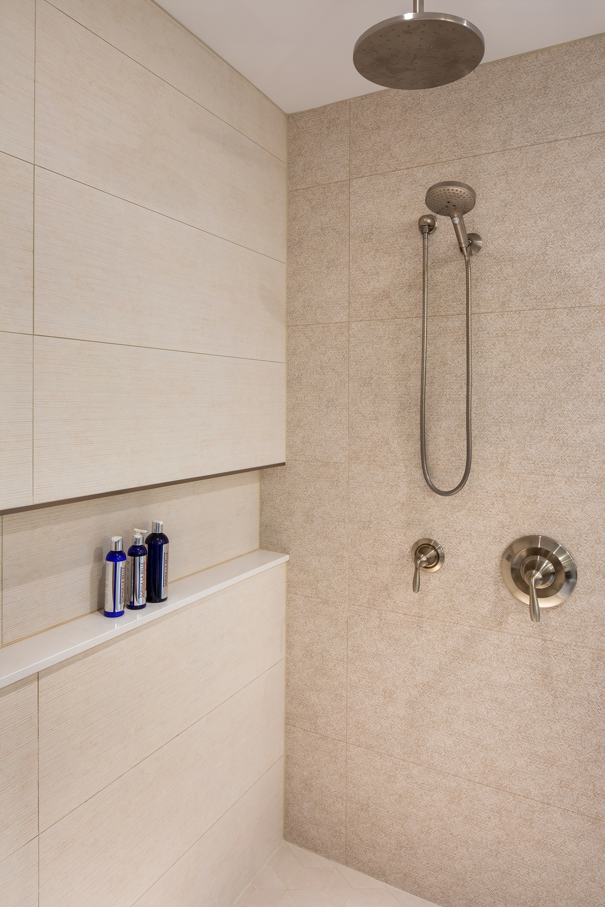 Primary bathroom with walk-in shower, modern fixtures, and high-quality finishes in second-story addition