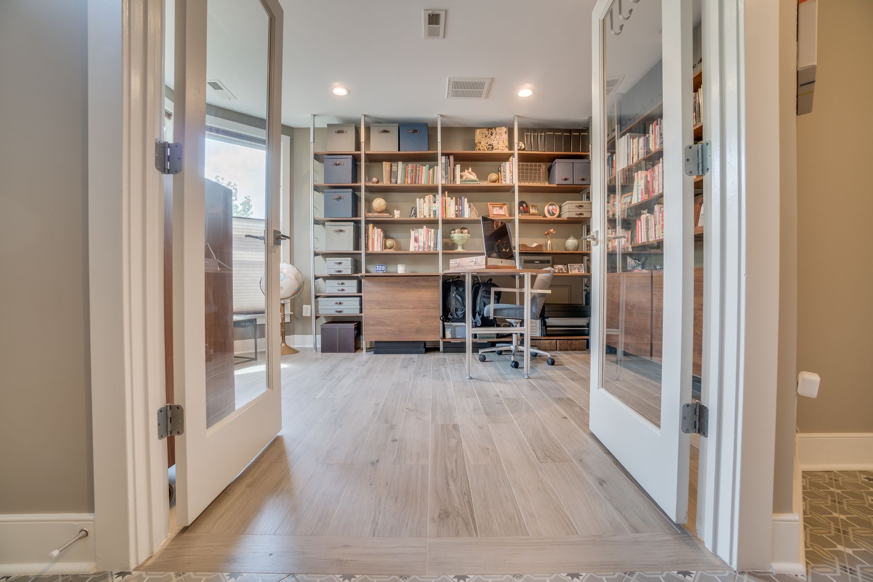 Entry area featuring artistic ceramic tile, contemporary lighting, and thoughtful design elements in updated rowhouse