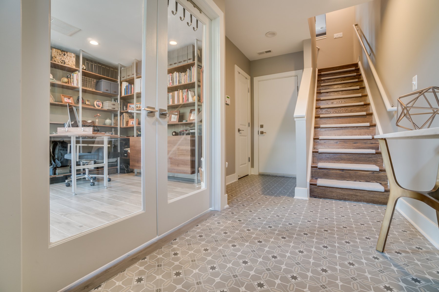 Modern home office with light wood-like tile flooring, sleek furnishings, and bright design in renovated Capitol Hill rowhouse