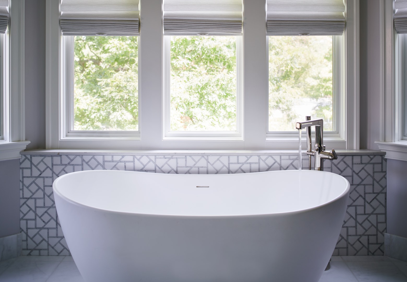 Walk-in shower with designer tile, frameless glass enclosure, and spa-like features in renovated bathroom space