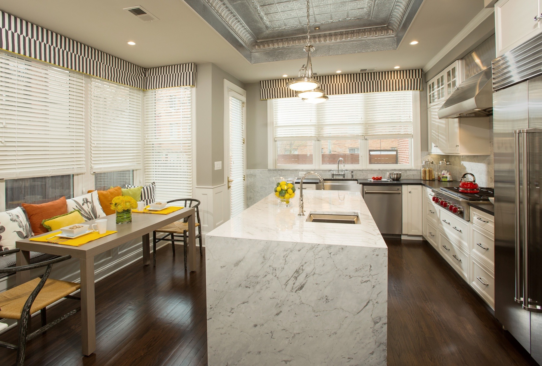 Living area with refinished wood floors, new recessed lighting, and architectural trim details in Capitol Hill renovation