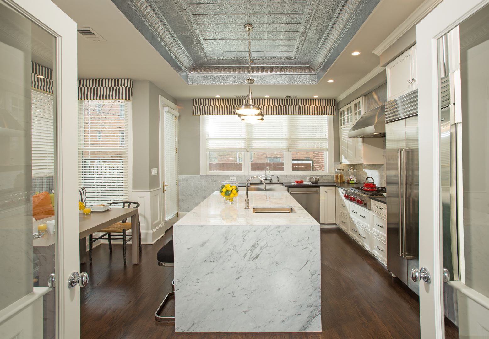 Transformed Capitol Hill kitchen featuring French doors, elegant cabinetry, and thoughtful design that blends modern functionality with historic character