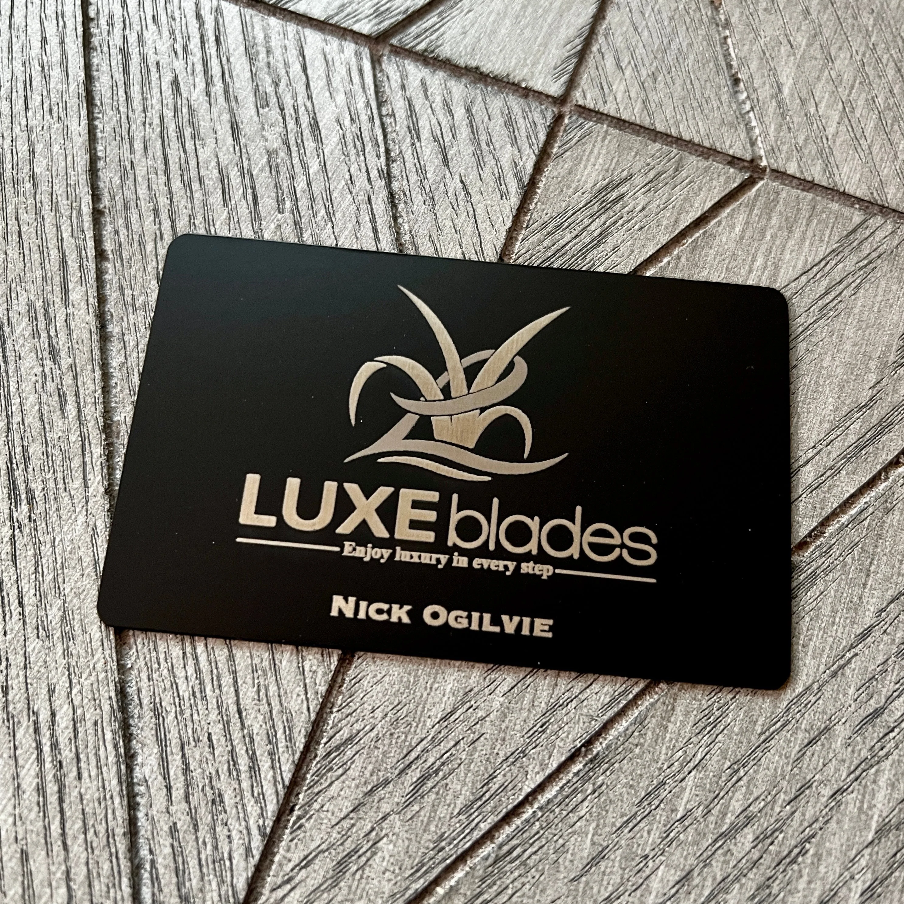 Black Luxe Blades metal business card with silver engraving
