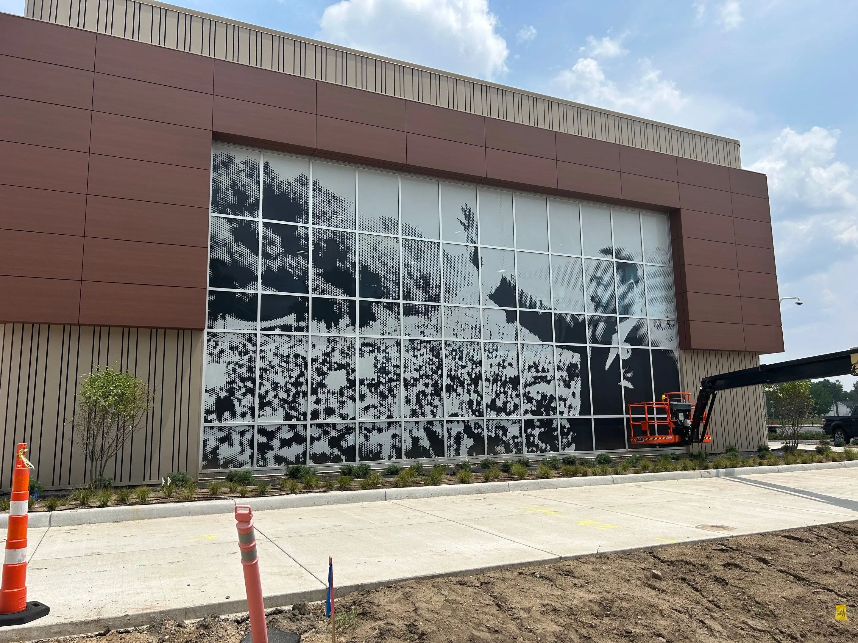 Exterior window vinyl on window panels being installed by Hayes Design Co. of an image of Dr. Martin Luther King Jr. at the MLK building