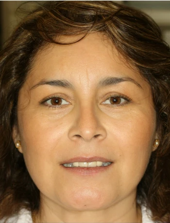Close-up of a middle-aged woman with brown eyes and wavy brown hair smiling slightly.