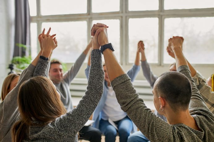 Rehab group celebrating during addiction recovery process