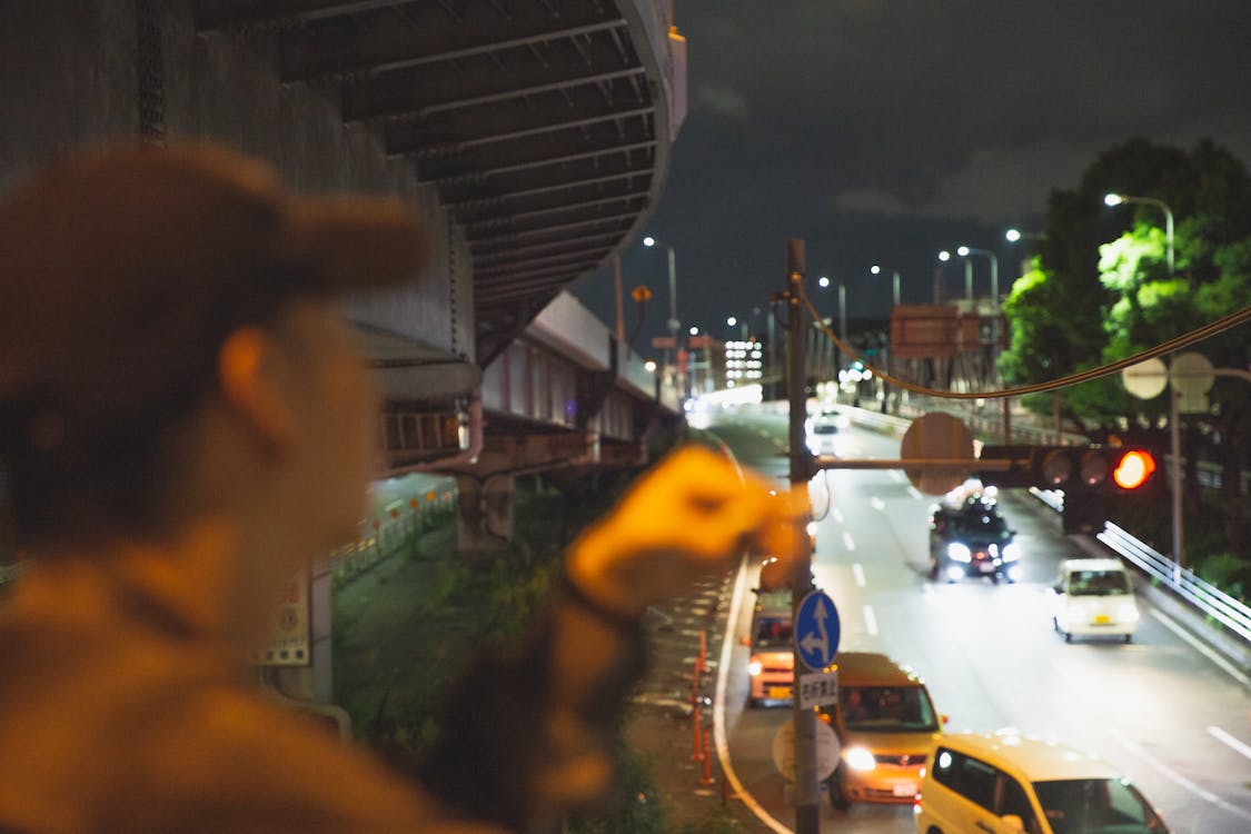 Free Man smoking and looking at traffic in city Stock Photo