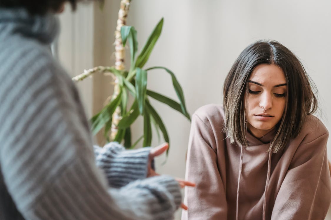 Free Unhappy woman having argument with crop female Stock Photo